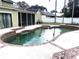 Kidney shaped pool with brick coping and landscaping at 9524 Bay Vista Estates Blvd, Orlando, FL 32836