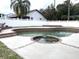 Kidney-shaped pool with brick coping and spa at 9524 Bay Vista Estates Blvd, Orlando, FL 32836