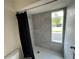 Modern shower with gray tile and a window at 9524 Bay Vista Estates Blvd, Orlando, FL 32836