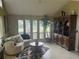 Sunroom with large windows and comfortable seating at 9524 Bay Vista Estates Blvd, Orlando, FL 32836
