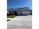 Charming single-story home featuring a well-manicured lawn, a two-car garage, and neutral-toned siding at 3443 Islewood Ct, Ocoee, FL 34761