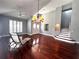 Open living area with rich wood floors, grand front doors, statement chandelier, and staircase at 1817 Baillie Glass Ln, Orlando, FL 32835