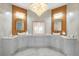 Elegant bathroom with dual vanities, large mirrors, and chandelier at 222 Acadia Ter, Celebration, FL 34747