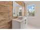 Elegant bathroom with wood-like tile and a modern sink at 222 Acadia Ter, Celebration, FL 34747