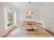 Elegant dining room with large window, oval wood table, and chandelier at 222 Acadia Ter, Celebration, FL 34747
