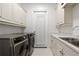 Bright laundry room with a double sink and ample cabinetry at 222 Acadia Ter, Celebration, FL 34747
