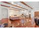 Spacious living room with hardwood floors, exposed beams, and a stone fireplace at 222 Acadia Ter, Celebration, FL 34747