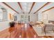 Spacious living room with hardwood floors, exposed beams, and a stone fireplace at 222 Acadia Ter, Celebration, FL 34747