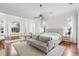 Bright main bedroom with hardwood floors, large windows, and sitting area at 222 Acadia Ter, Celebration, FL 34747