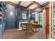 Dark-blue home office with wood-burning fireplace, built-in bookshelves, and hardwood floors at 222 Acadia Ter, Celebration, FL 34747