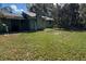 Mature backyard and home are awaiting renovations for the right homeowner at 1440 Walker Rd, Lakeland, FL 33810