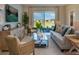 Bright living room featuring neutral furniture, area rug, a glass coffee table, and sliding glass doors to the outside at 168 Duckweed Ave, Fruitland Park, FL 34731