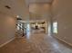 Bright, open-concept living space featuring tile floors and a staircase leading to the upper level at 1227 Teal Creek Dr, Saint Cloud, FL 34771