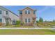 Charming two-story home featuring manicured lawn and stone landscaping in the front yard at 1231 Teal Creek Dr, St Cloud, FL 34771