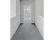 Hallway with carpeted floor leading to a room with natural light at 1231 Teal Creek Dr, St Cloud, FL 34771
