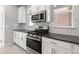 Well-equipped kitchen featuring modern stainless steel appliances, sleek cabinetry and gray countertops at 1231 Teal Creek Dr, St Cloud, FL 34771