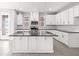 Bright, modern kitchen featuring an island, stainless appliances, white cabinets, and ample countertop space at 1231 Teal Creek Dr, St Cloud, FL 34771