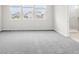 Carpeted primary bedroom with three large windows and an ensuite bathroom at 1231 Teal Creek Dr, St Cloud, FL 34771