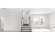 Contemporary staircase with wood railing and tile flooring leading to the upper level of the home at 1231 Teal Creek Dr, St Cloud, FL 34771