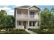 Two-story house with balcony, light beige siding, and landscaping at 5239 Kildare Pl, St Cloud, FL 34771