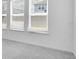 Cozy bedroom featuring three windows, plush carpet, and neutral walls at 5267 Stone Ridge Pl, St Cloud, FL 34771