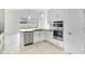 Kitchen featuring an island with a sink and stainless steel appliances at 5267 Stone Ridge Pl, St Cloud, FL 34771