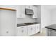 Kitchen area featuring stainless steel appliances and white cabinetry at 5267 Stone Ridge Pl, St Cloud, FL 34771