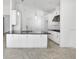 Open concept kitchen area with a center island and black countertops at 5267 Stone Ridge Pl, St Cloud, FL 34771