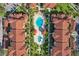 Aerial view of community amenities including a pool, spa, cabana, and lush landscaping at 5536 Metrowest Blvd # 8-304, Orlando, FL 32811