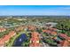 An aerial view showcases a condo community with a pool, pond and nearby highway at 5536 Metrowest Blvd # 8-304, Orlando, FL 32811