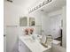 Bright bathroom features a white vanity, large mirror, and modern fixtures, reflecting a clean design at 5536 Metrowest Blvd # 8-304, Orlando, FL 32811
