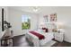 Bedroom featuring a large window, stylish decor, and ample natural light at 5536 Metrowest Blvd # 8-304, Orlando, FL 32811