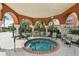 A close view of a hot tub, surrounded by chairs, supported by pillars, and landscaped at 5536 Metrowest Blvd # 8-304, Orlando, FL 32811