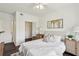 Bright bedroom with white walls, ceiling fan, and walk-in closet offers comfortable living space at 5536 Metrowest Blvd # 8-304, Orlando, FL 32811