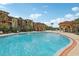 A community pool with fountains, gazebos, palm trees and building in background at 5536 Metrowest Blvd # 8-304, Orlando, FL 32811