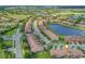 Aerial view of community, showing home location, golf course, and lake at 10747 Belfry Cir, Orlando, FL 32832