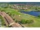 Aerial view showcasing homes adjacent to a golf course at 10747 Belfry Cir, Orlando, FL 32832