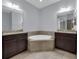 Spacious bathroom with double vanity, soaking tub, and separate shower at 10747 Belfry Cir, Orlando, FL 32832