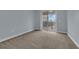 Bright bedroom with neutral walls and carpet flooring, and access to balcony at 10747 Belfry Cir, Orlando, FL 32832