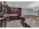 Modern kitchen with dark wood cabinets and granite countertops at 10747 Belfry Cir, Orlando, FL 32832
