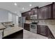 Stainless steel appliances and granite countertops highlight this kitchen at 10747 Belfry Cir, Orlando, FL 32832