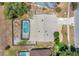 Overhead aerial showing the house roof, screened pool, landscape features and surrounding neighborhood at 1121 Trotwood Blvd, Winter Springs, FL 32708