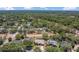 Expansive aerial view of a residential neighborhood with tree-lined streets, lush greenery, and single-Gathering homes with private yards at 1121 Trotwood Blvd, Winter Springs, FL 32708