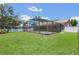 Beautiful backyard showcasing a screened pool area, blending indoor and outdoor living seamlessly at 1121 Trotwood Blvd, Winter Springs, FL 32708