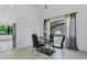 Contemporary dining room featuring a glass table with black chairs, and a window offering natural light at 1121 Trotwood Blvd, Winter Springs, FL 32708