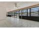 Large screened lanai featuring tile floors, ceiling fans, and sliding glass doors overlooking the pool at 1121 Trotwood Blvd, Winter Springs, FL 32708