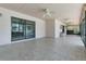 Spacious screened lanai with tile flooring, fans, and access to the pool area through sliding doors at 1121 Trotwood Blvd, Winter Springs, FL 32708