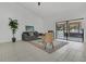 Inviting living room with neutral decor, tile flooring, and sliding glass doors offering pool views and natural light at 1121 Trotwood Blvd, Winter Springs, FL 32708