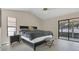 Spacious main bedroom with vaulted ceilings, neutral paint, and sliding glass door to the lanai at 1121 Trotwood Blvd, Winter Springs, FL 32708