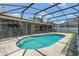 Refreshing private pool with screened enclosure and paved deck, surrounded by lush landscaping at 1121 Trotwood Blvd, Winter Springs, FL 32708